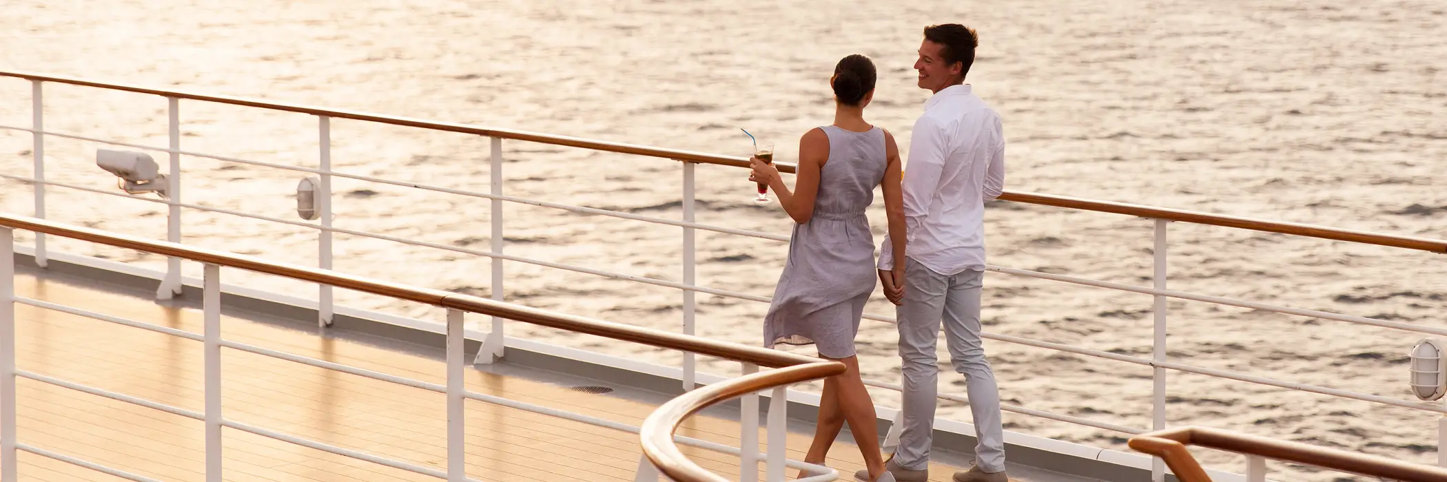Couple on a cruise ship enjoying the view of the sea
