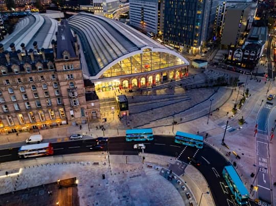 Passengers with suitcases arriving at Liverpool Lime Street station